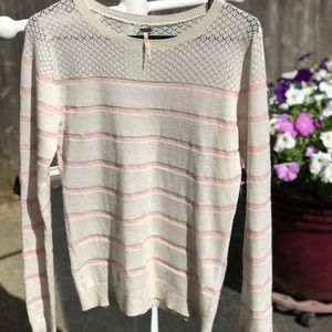 Light sweater with cutout prints design on top.
